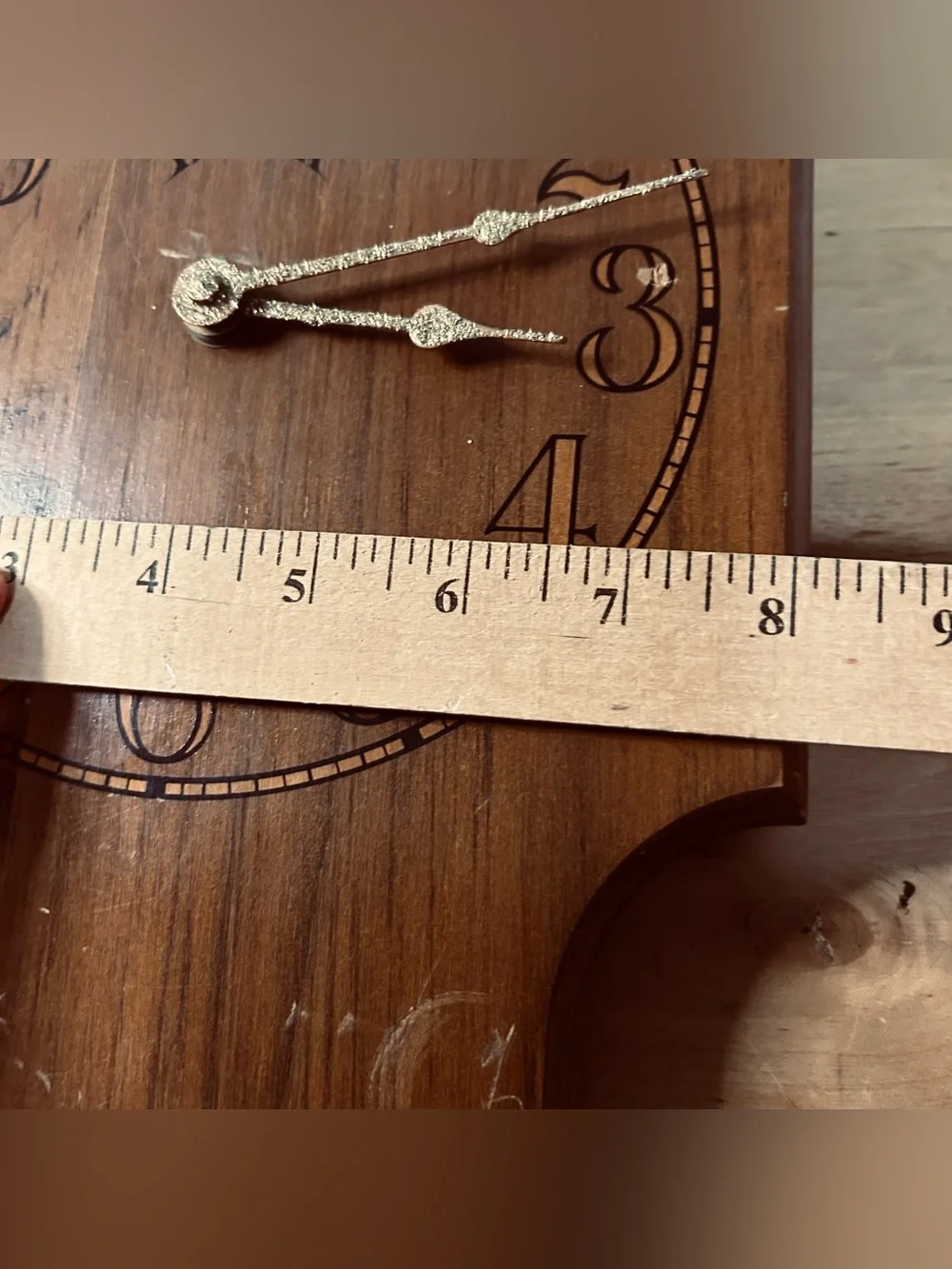 Bulova wall clock features a unique wooden casing shaped like a stylized ship
